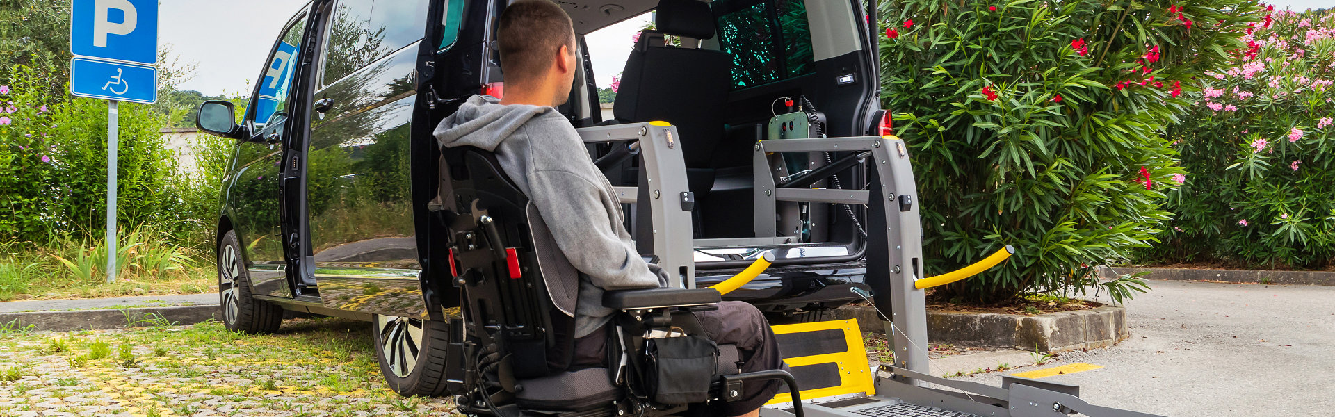 man on wheelchair preparing to board the van