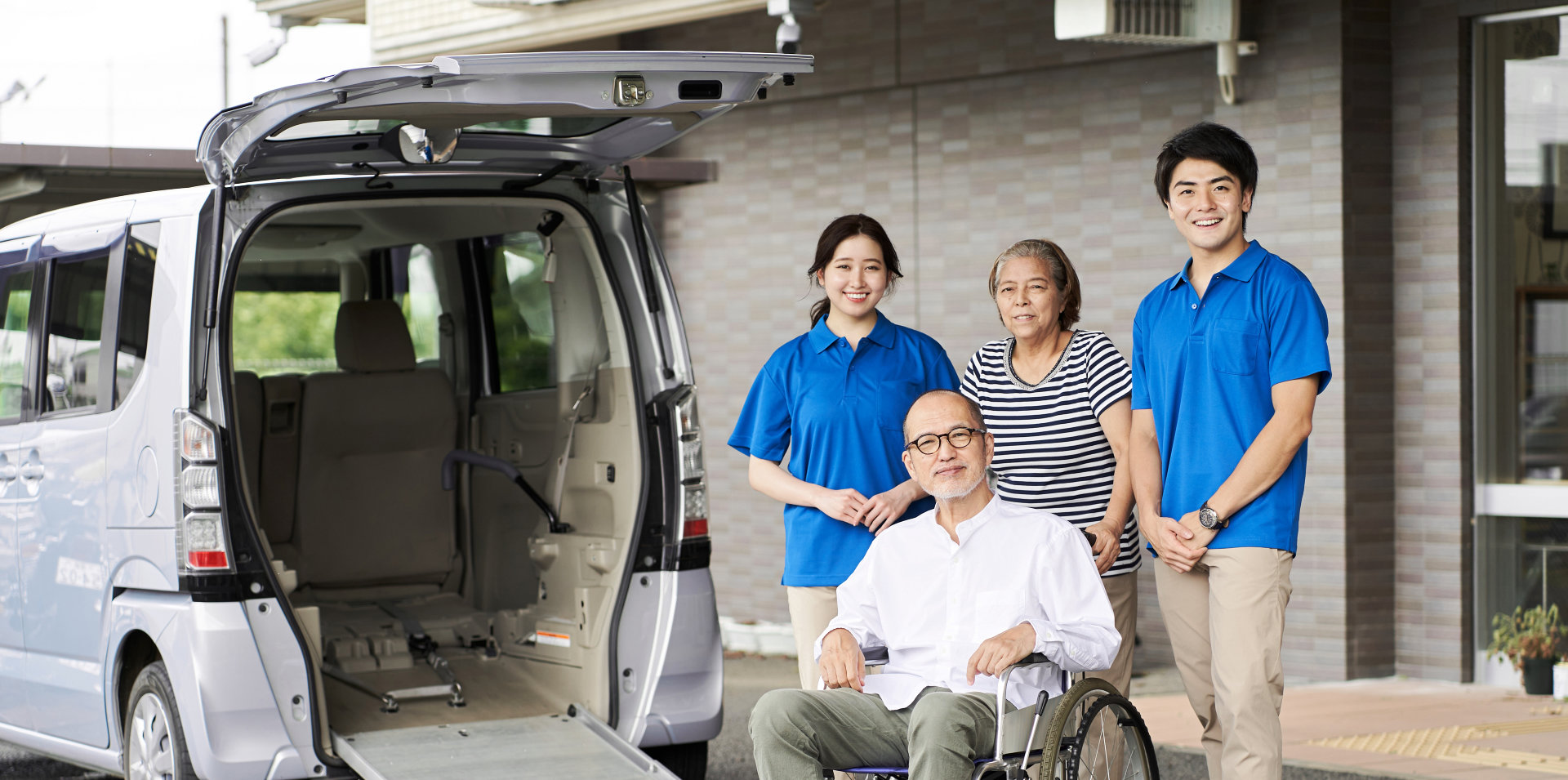 caregivers and their patients preparing to board a van